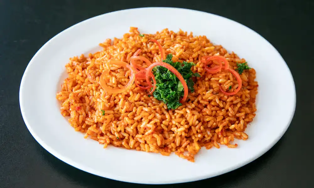 Jollof Rice with Stewed Meats - Authentic Nigerian jollof rice served at Global Pot Fusion Cuisine Winnipeg